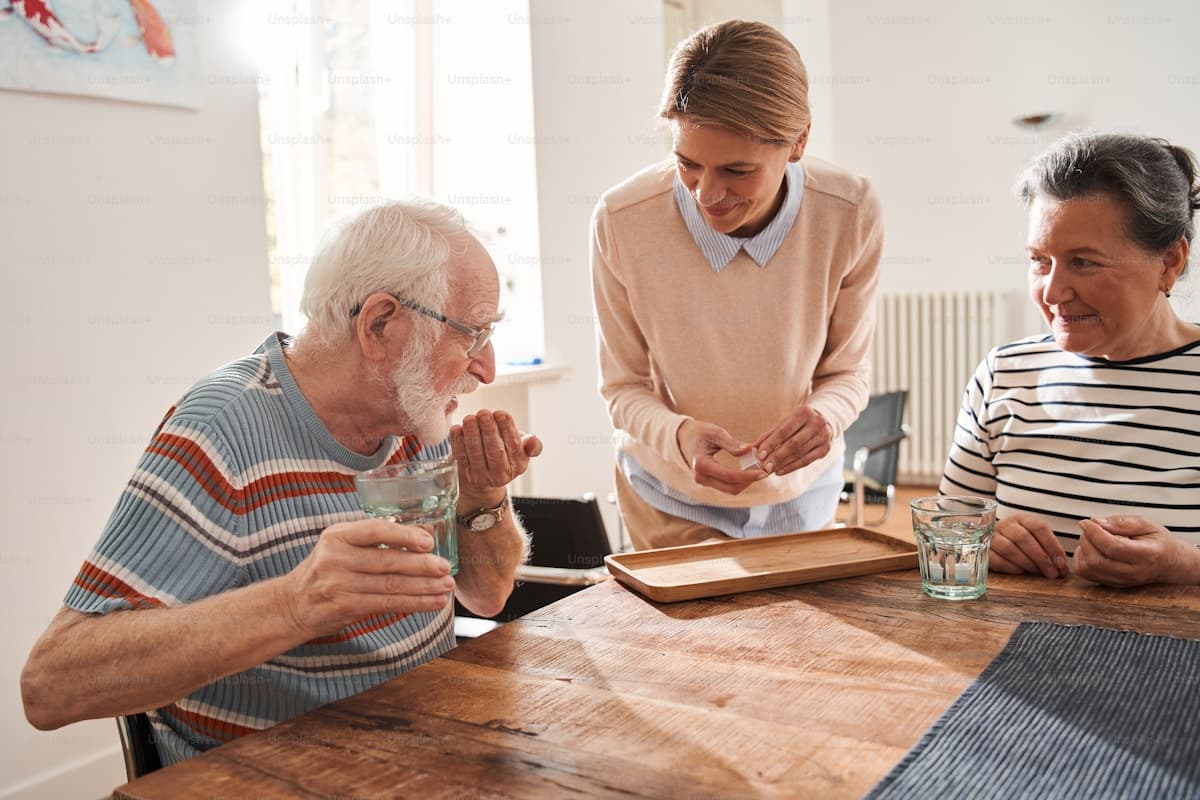 A caregiver helping a senior with daily medication